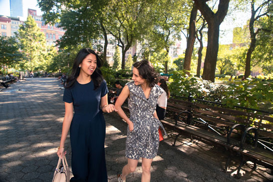 2 women laugh together as they walk through Union Square