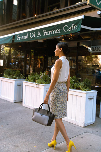 A woman in yellow heels walks past Friend of a Farmer Cafe