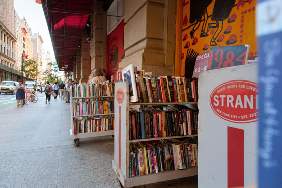 3 wheeled carts full of books sit outside NYC's Strand bookstore