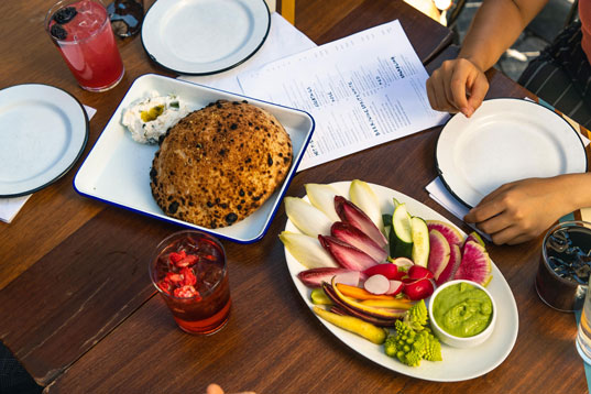 A table full of colorful vegetables and bread